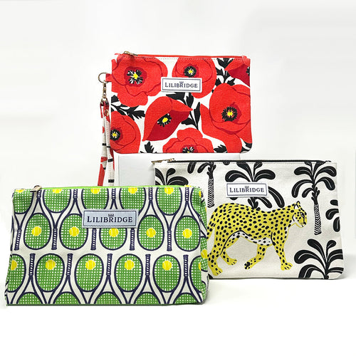 small accessory collection including the wristlet, clutch, and makeup bag