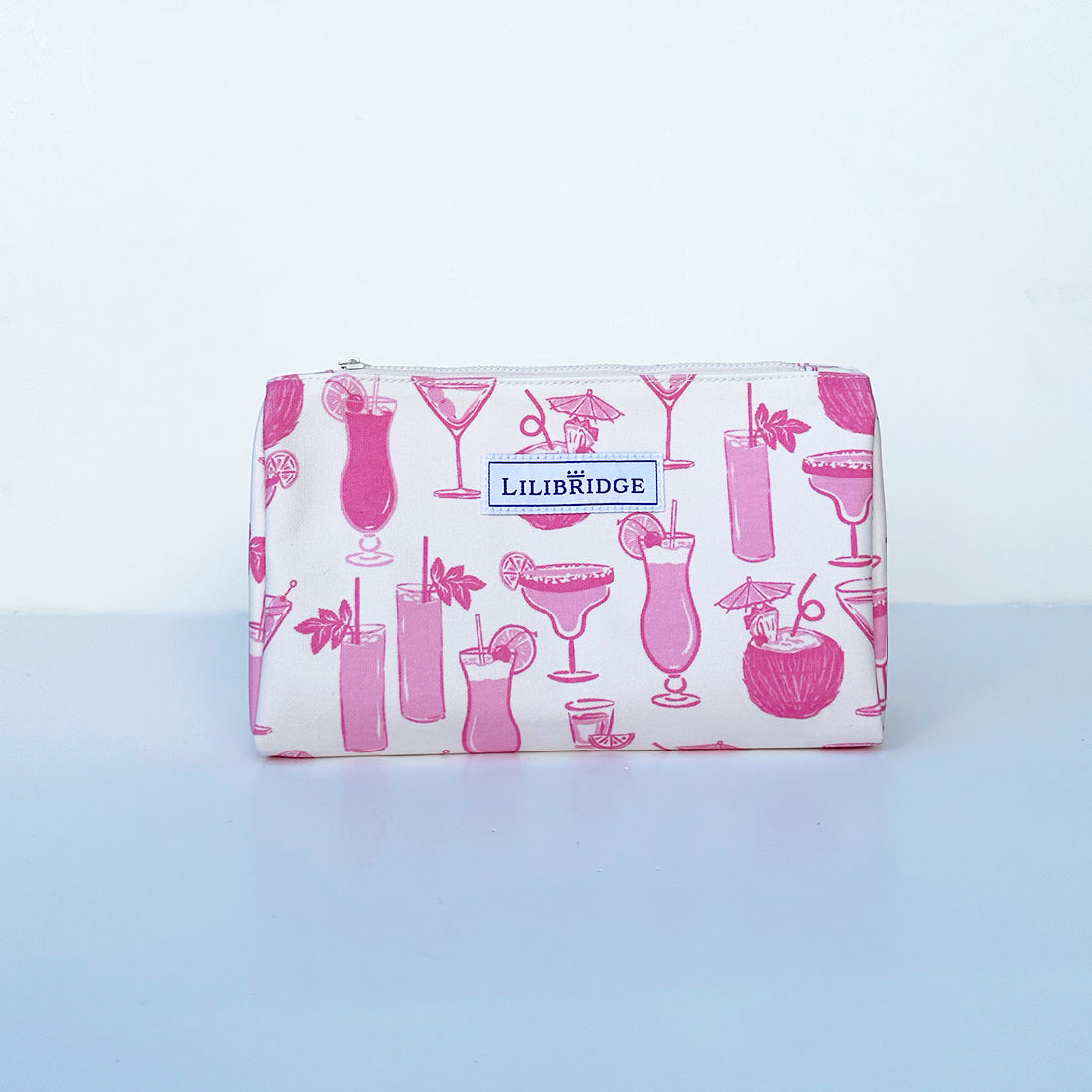 makeup bag with illustrated cocktails in pink on white canvas background