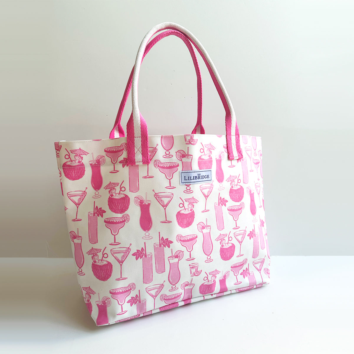 Tote bag with pink cocktail pattern on a white background