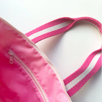 close up of pink lining and interior zipper of mini tote bar